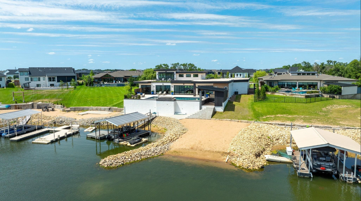 Another view of the exterior of the home at 4835 W. Brisco in west Wichita, which features a sandy beach area and a dock.