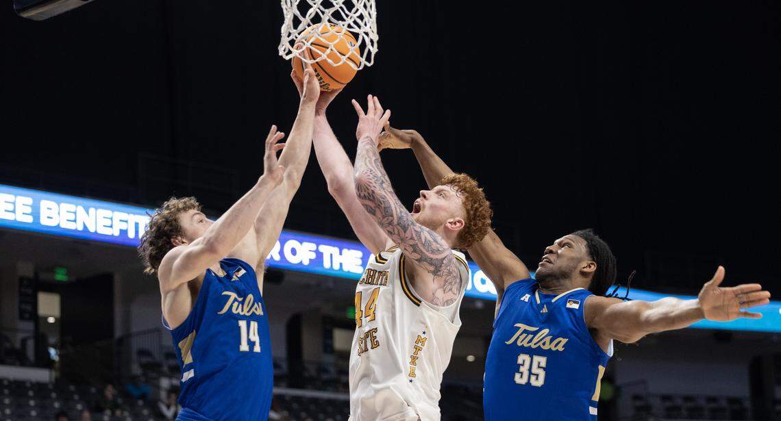 Wichita State’s Will Berg puts up a shot against Tulsa defenders Miles Barnstable, left, and Ian Smikle during the first half of their AAC tournament semifinal game on Saturday in Birmingham.