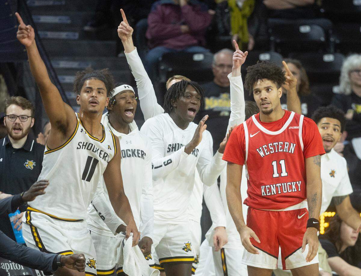Wichita State players celebrate a turnover by Western Kentucky’s Dontaie Allen during the first half of their game at Koch Arena on Thursday night. 