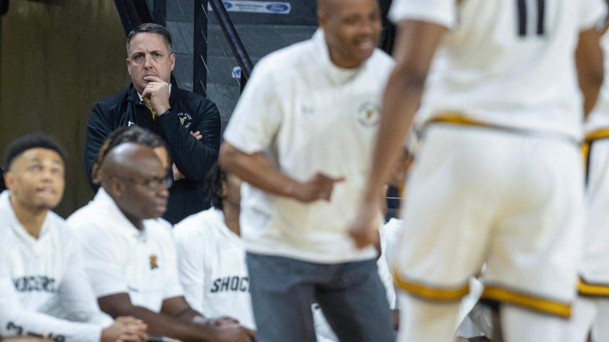 WIchita State athletic director Kevin Saal watches head basketball coach Isaac Brown form the tunnel leading to the locker room during a game last December at Koch Arena.