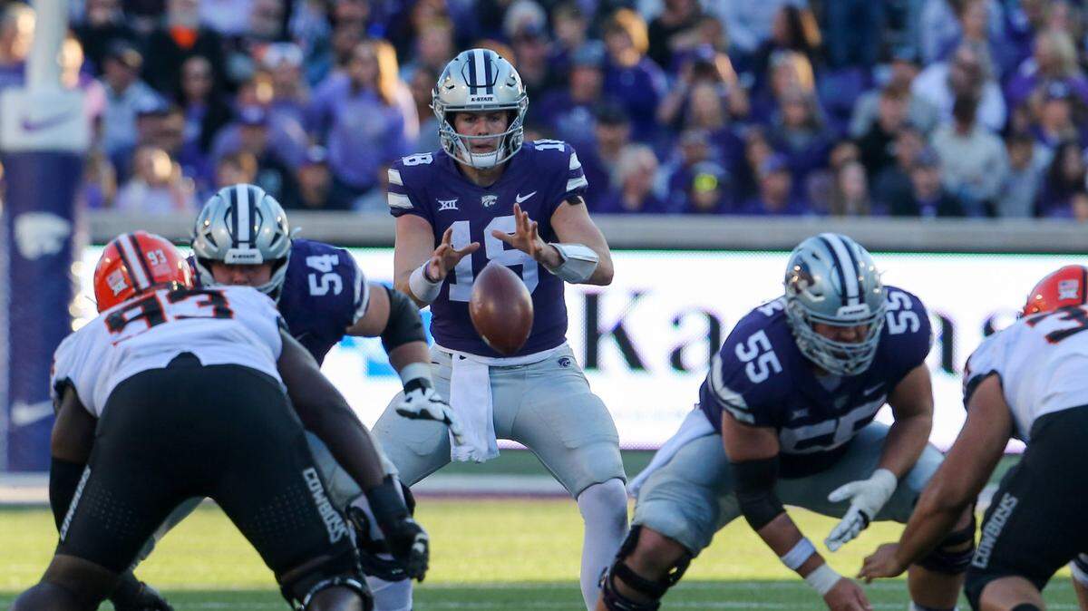 Kansas State Wildcats quarterback Will Howard (18) takes the snap from center Hayden Gillum (55) against the Oklahoma State Cowboys during the fourth quarter at Bill Snyder Family Football Stadium.