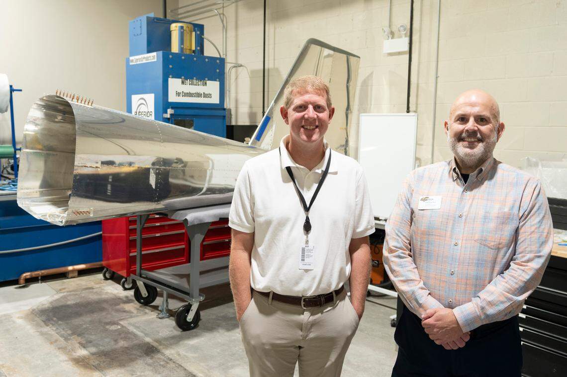 USD 259’s Kelly Bielefeld, left, and WSU Tech’s Scott Lucas stand in front of a Van’s Aircraft RV-12 kit plane that high school students have started to build in the former Dillons at 13th and Waco. The building is one of three new centers that USD 259 and WSU Tech are creating to help train high school students and alleviate jobs shortages in the future. This one will serve the manufacturing and aviation sectors.