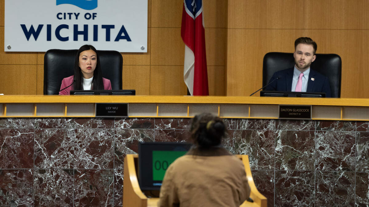 Wichita mayor Lily Wu and council member Dalton Glasscock listen to a speaker regarding the reversal of local campaign finance reforms put in place in January by the previous mayor and council. The council voted 7-0 to allow corporations to donate again but also required that the name of the principal owner of the corporation be listed.