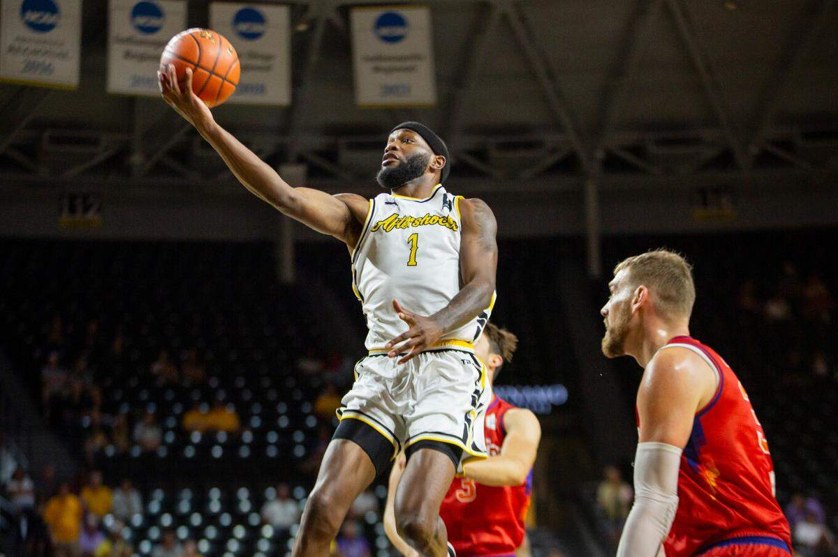 Markis McDuffie soars through the lane for a basket to help the AfterShocks to an opening-round win over Midtown Prestige at Koch Arena on Saturday afternoon.