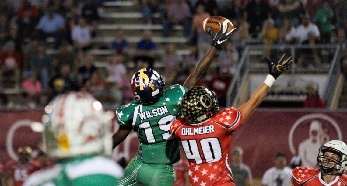 Valley Center’s Larry Wilson goes up for a one-handed catch over Paola’s Brendan Ohlmeier during the West team’s 26-7 win over the East in the 2019 Kansas Shrine Bowl in Dodge City.