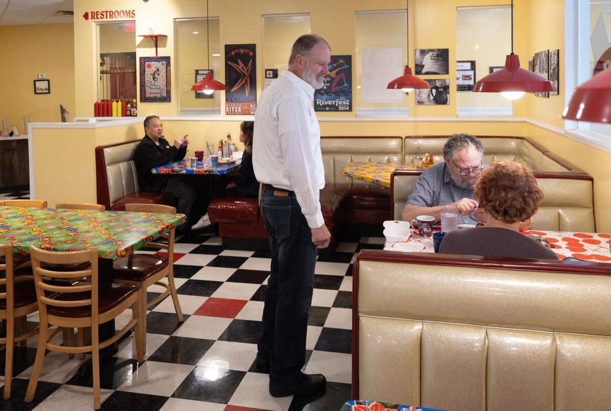 Jay Miller visits with customers at Doo-Dah Diner. Jay and his brother Jeff are buying the diner from founders Patrick and Timirie Shibley.