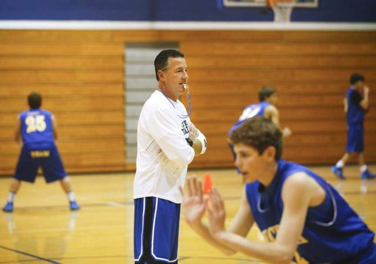 Collegiate basketball coach Mitch Fiegel works with his team during a practice over the Thanksgiving break in 2013.