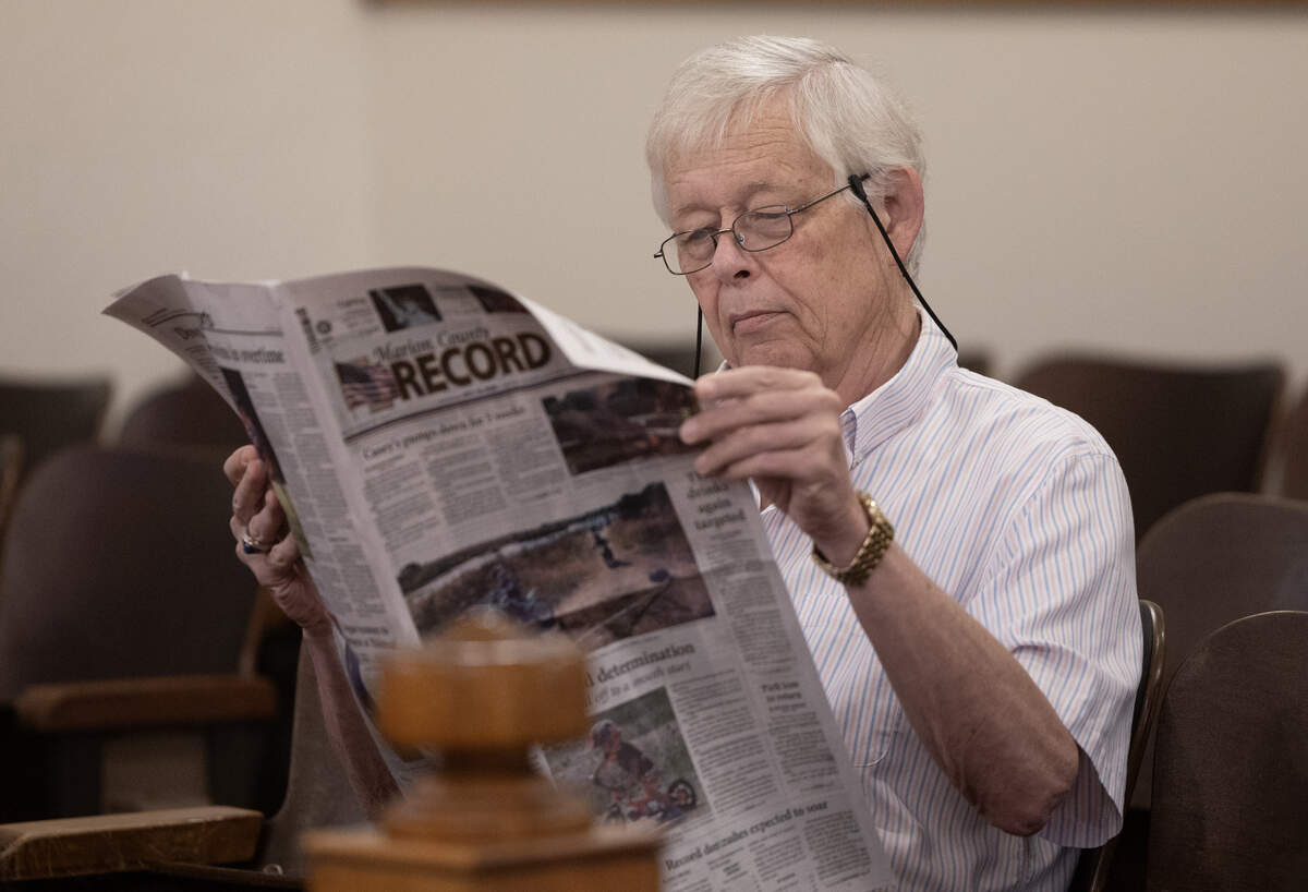 Eric Meyer, the editor of the Marion County Record, looks at his newspaper during a preliminary hearing for former Marion police chief Gideon Cody on Tuesday. Prosecutors allege that Cody instructed a former Marion restaurant owner, Kari Newell, to delete text messages between them in the days following a raid that Cody oversaw at the Record, Meyers’ home and the home of the town’s vice mayor in August 2023.