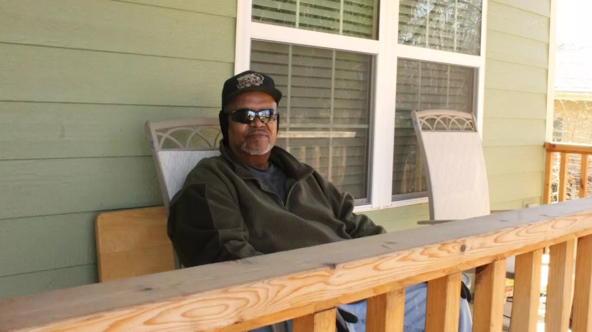 First-time homeowner Greg Thompson sits on his front porch in northeast Wichita.