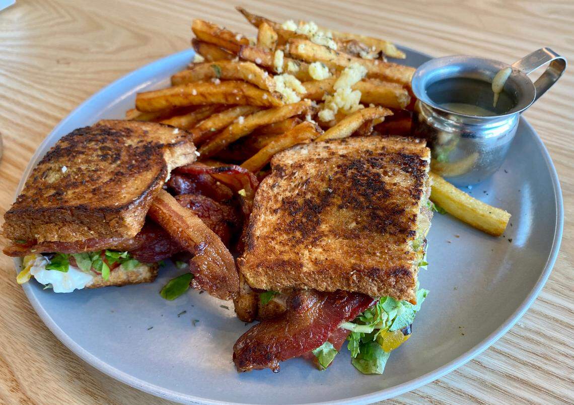 First Mile Cantine’s menu features a B.L.T. made with smoked bacon, tomato, burrata cheese, walnut basil pesto and field greens. Truffle fries are served on the side.