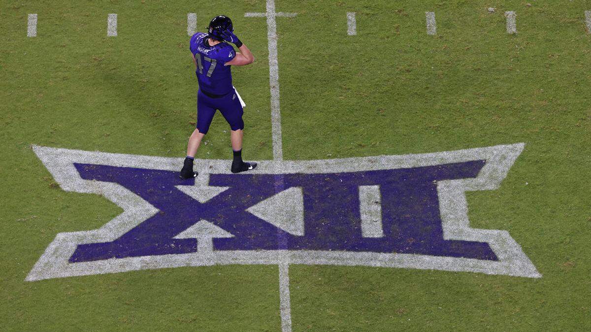 TCU tight end Carter Ware (47) walks across a Big 12 Conference logo as TCU plays Duquesne during the second half of an NCAA college football game Saturday, Sept. 4, 2021, in Fort Worth, Texas. TCU won 45-3. (AP Photo/Ron Jenkins)