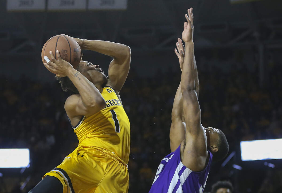 Wichita State’s Tyson Etienne shoots over Abilene Christian’s Joe Pleasant during the second half of their game at Koch Arena on Sunday.