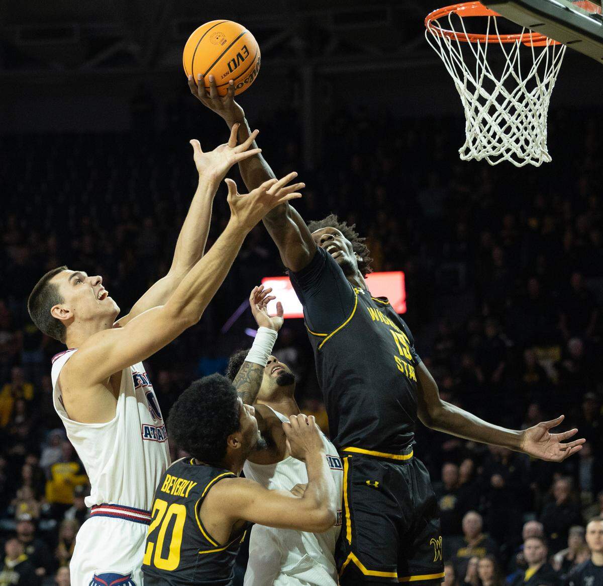 Florida Atlantic’s Vladislav Goldin tries to get to the basket against Wichita State defender Quincy Ballard during the first half on Sunday.