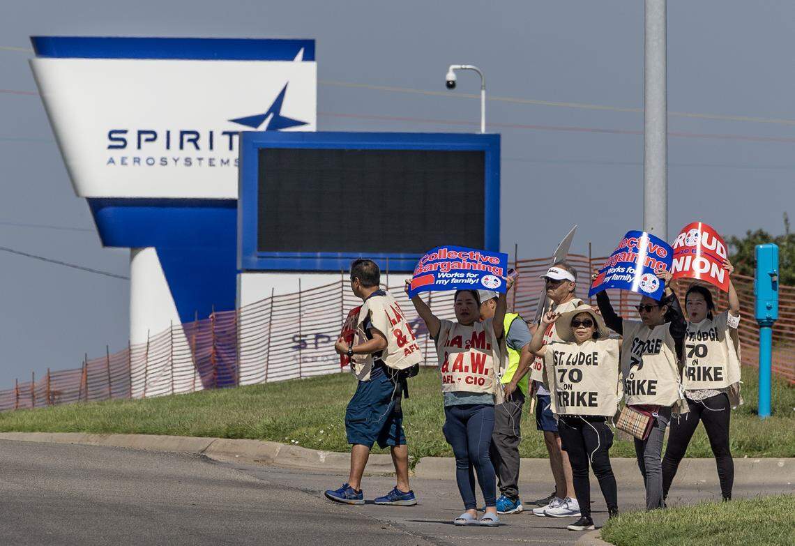 Striking aerospace workers picket outside the Spirit AeroSystems factory on Saturday morning. Members of the Machinists union voted down a proposed contract from Spirit earlier this week.