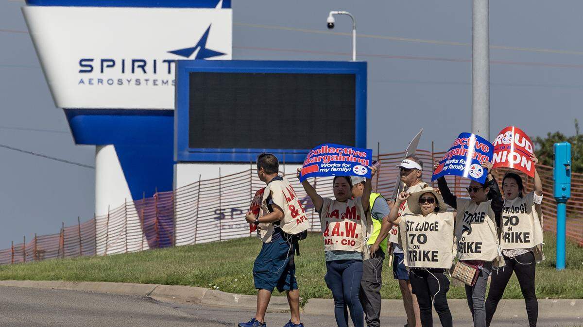 Striking aerospace workers picket outside of the Spirit AeroSystems factory on Saturday morning. Members of the machinist union voted down a proposed contract from Spirit earlier this week and voted to strike. The the strike began at midnight Saturday morning.