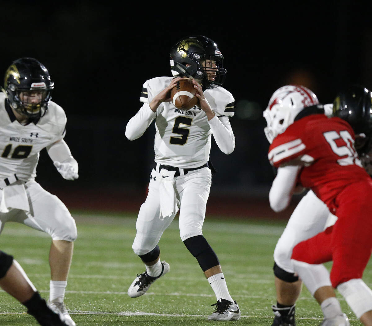 Maize South quarterback #5Colin Shields  looks for a receiver Friday night as Maize South took on Maize.  (November 2, 2018)