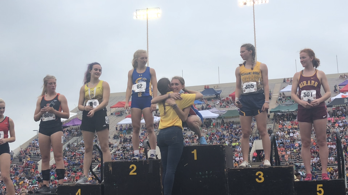 Cheney senior Layne Needham (center) hugged her older sister, Taylor, after Layne won her fifth state championship in total with a 300-meter hurdles Class 3A title at the state track meet at Cessna Stadium on Saturday.