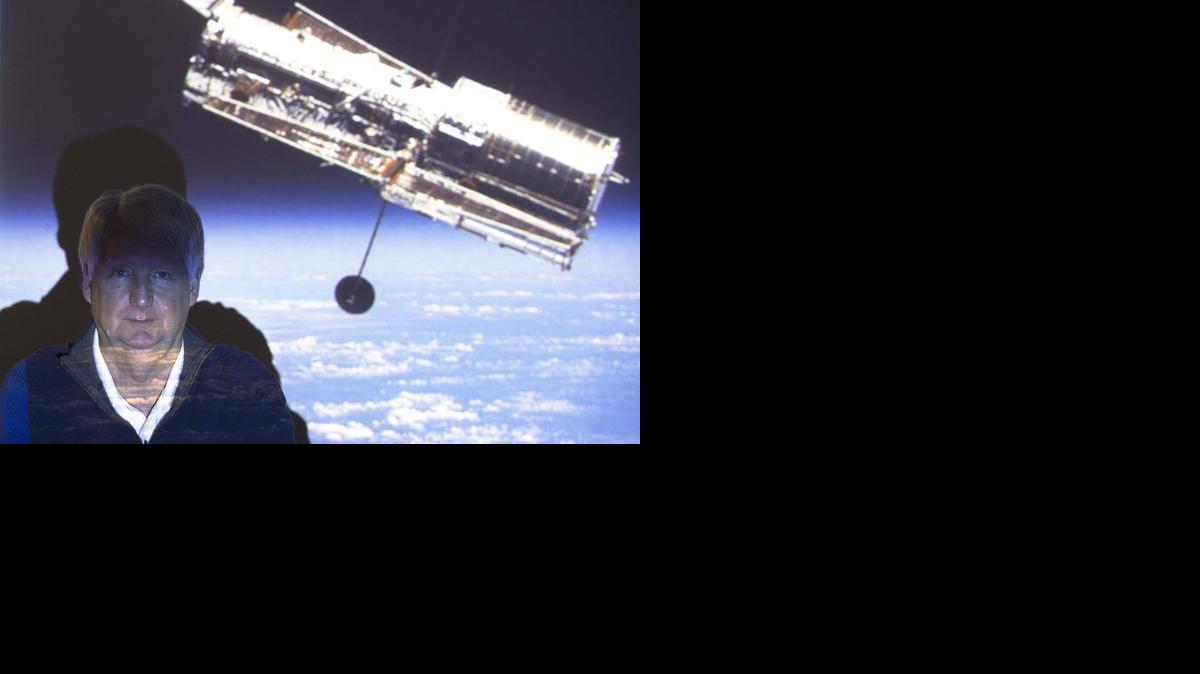 University of Kansas professor Steve Hawley sits in front of a projected photo of the Hubble Space Telescope. Hawley, an astronomer and astronaut, made five flights into orbit on the Space Shuttle and was the person who deployed the Hubble into orbit.

