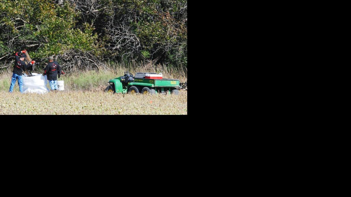 Recovery crews bag up parts left by a Cessna jet that crashed southeast of Derby on Friday, killing both the pilot and passenger on board.