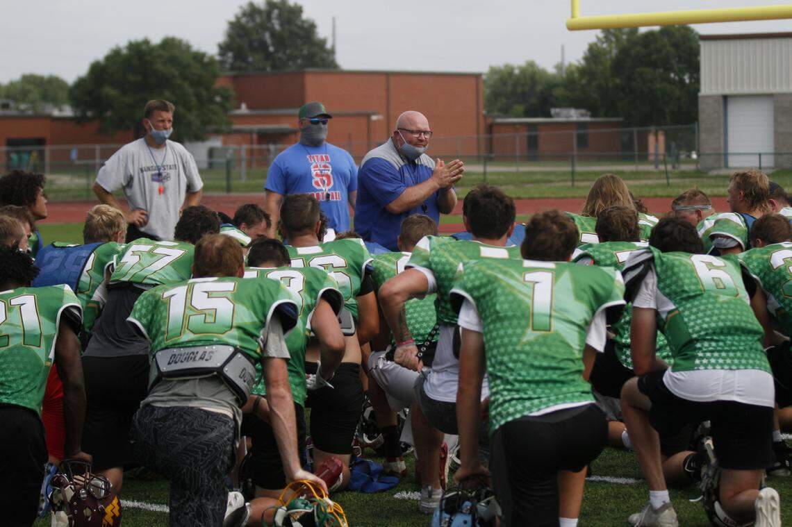 The 2020 Kansas Shrine Bowl players gather around West coach Tommy Beason, of Goddard, after practice.