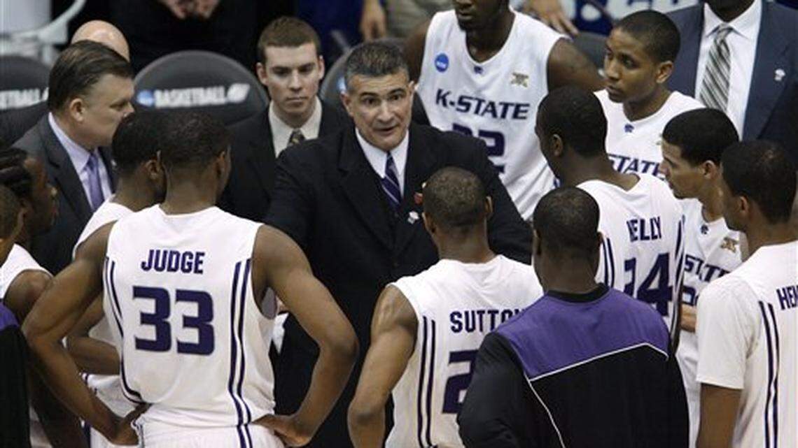 Kansas State head coach Frank Martin, center, talks to his team during a time out against Xavier in the first half of an NCAA West Regional semifinal college basketball game in Salt Lake City, March 25, 2010. (AP Photo/Steve C. Wilson)