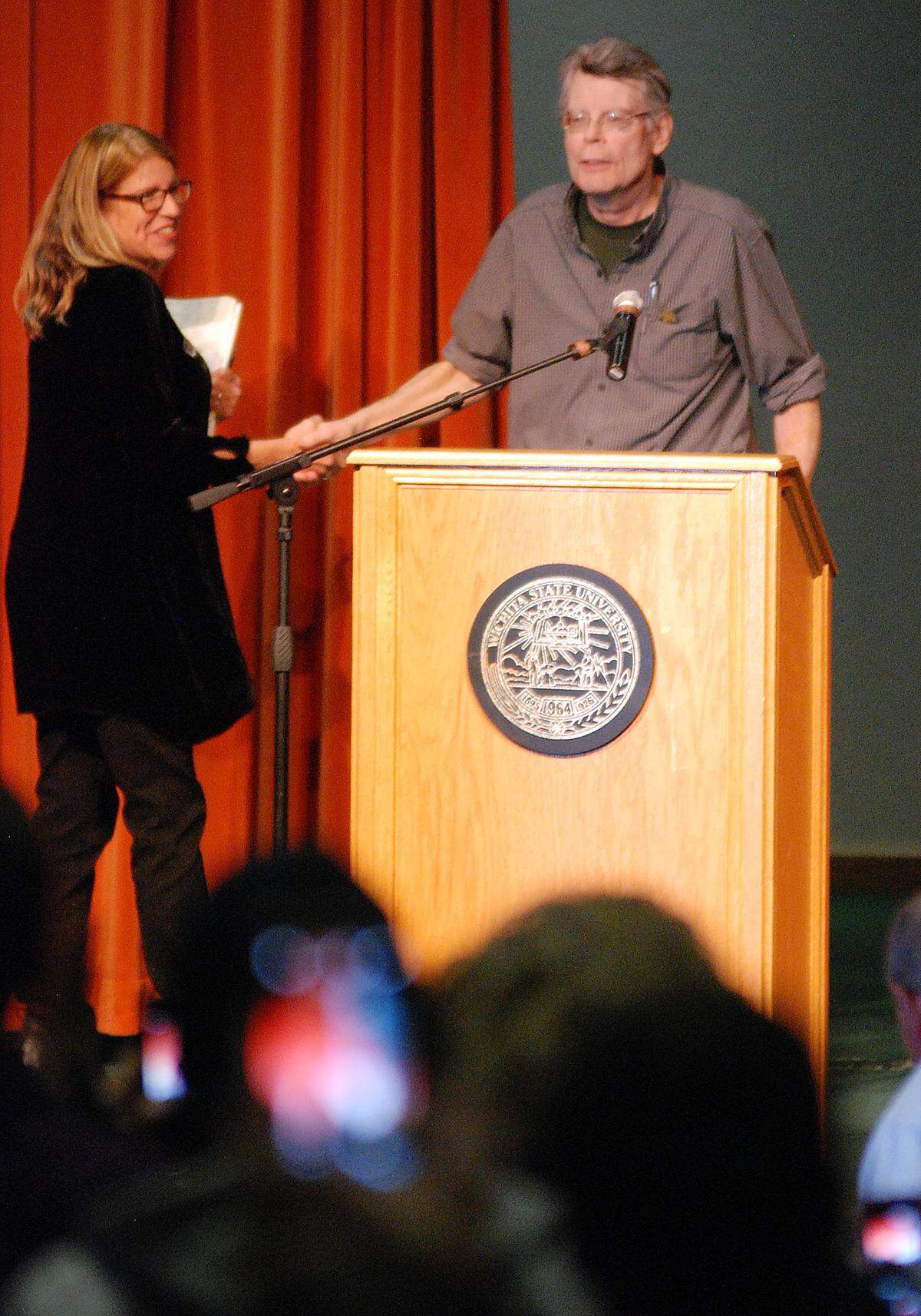 Watermark Books & Cafe owner Sarah Bagby introduces Stephen King to a large audience at the WSU Hughes Metroplex in this 2014 photo.