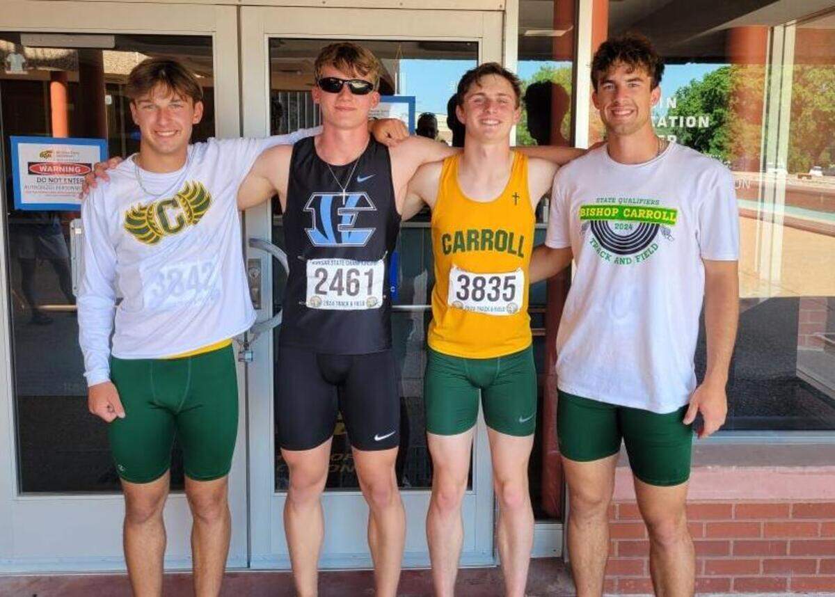 Goddard Eisenhower senior Justus Reynolds poses for a picture with Bishop Carroll hurdlers Noah Holthusen, Luke Holthusen and Caleb DeGroot. All four placed in the Class 5A 300-meter hurdles.