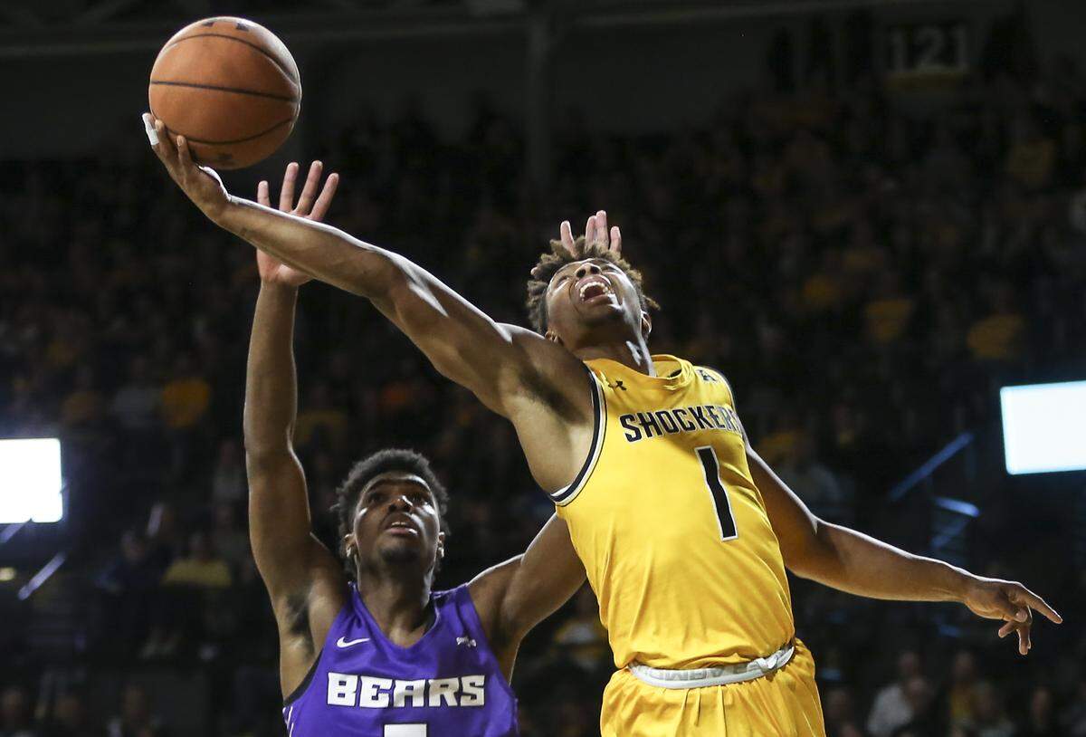 Wichita State’s Tyson Etienne goes to the basket against Central Arkansas’ Masai Olowokere during the second half at Koch Arena on Thursday.