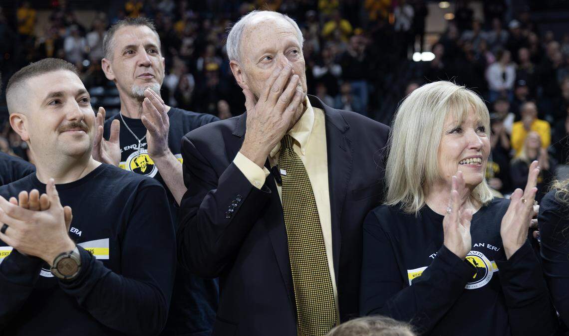 Wichita State radio broadcaster Mike Kennedy wipes away a tear as a banner honoring him is dropped from the rafters at Koch Arena on Saturday.
