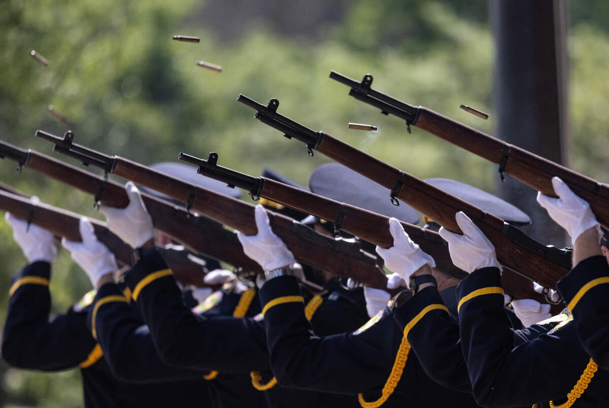 Shell casing fly from the rifles of an honor guard during a 21-gun salute in front of City Hall on Wednesday. The city and county honored all of the law enforcement officers who’ve died in the line of duty.