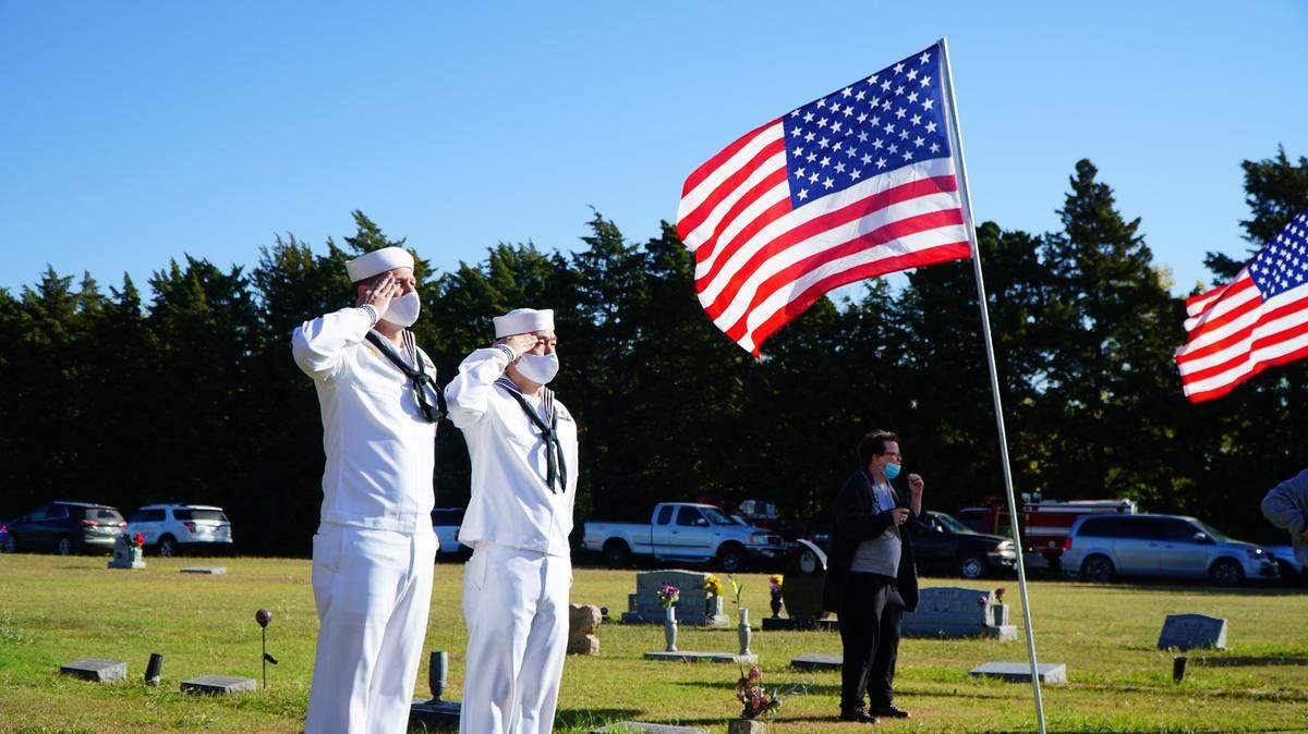 Members of the Wichita Navy Reserve stand at attention in October 2020 during a funeral for war veteran.