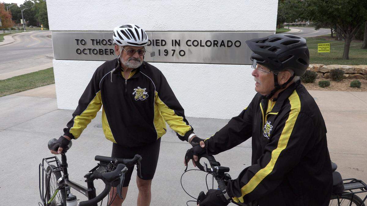 Rick Stephens and Paul Harrison (along with Kelly Harrison, not pictured) gather in prayers at the Wichita State Plane crash memorial before setting off for Colorado.