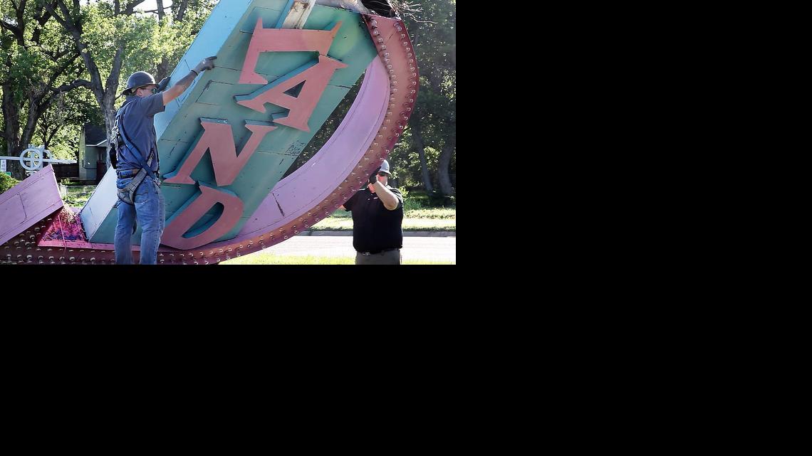 Workers with Miracle Signs remove the iconic Joyland sign that had lured families to the amusement park from 1949 to 2006. The sign has been purchased by the Historic Preservation Alliance of Wichita and Sedgwick County.

