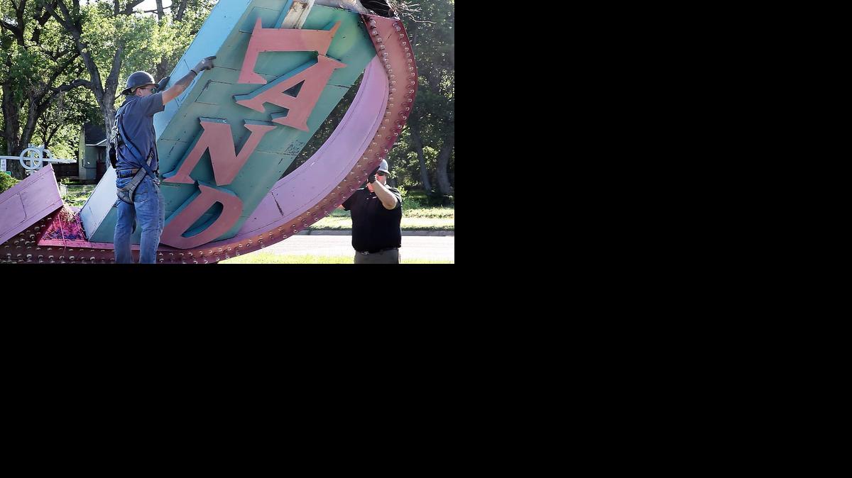 Workers with Miracle Signs remove the iconic Joyland sign that had lured families to the amusement park from 1949 to 2006. The sign has been purchased by the Historic Preservation Alliance of Wichita and Sedgwick County.

