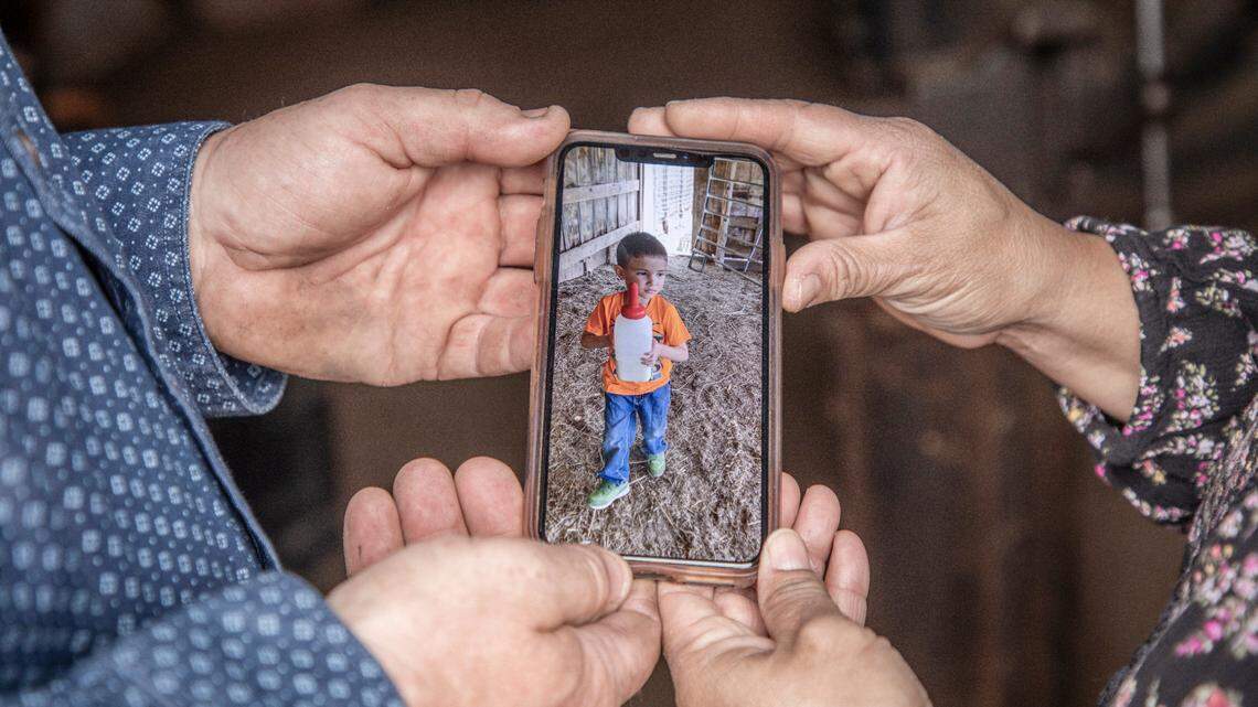 Jamie and Tina Miller hold a photograph of their former foster child, Aaron, on May 3, 2021, on the Merrill Ranch in Comanche County. Jamie is the ranch manager where he and his family also live.