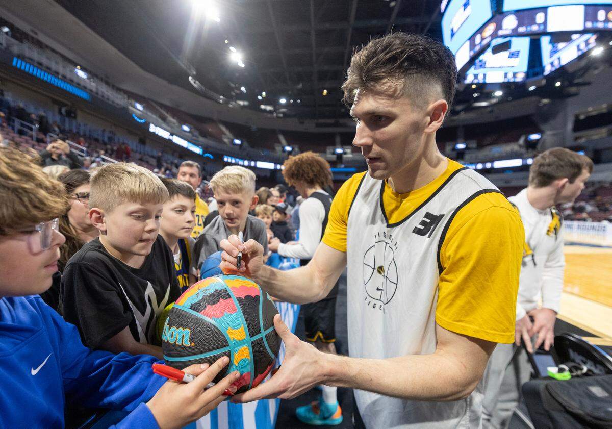 Missouri’s Caleb Grill signs autographs after the team’s open practice on Wednesday, March 19, 2025, in Wichita. Grill played at nearby Maize High School.