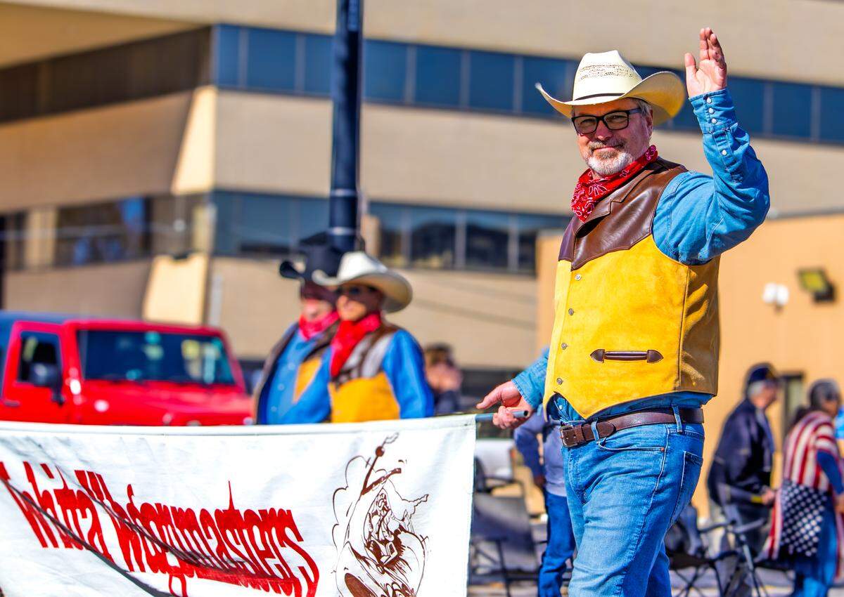 Members of Wichita Wagonmasters walk and wave during Wichita’s 2025 Veterans Day parade on Saturday, Nov. 8.