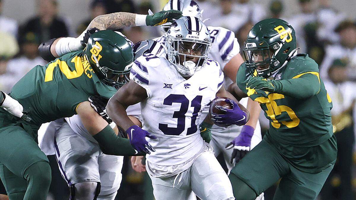 Kansas State running back DJ Giddens (31) runs between Baylor linebacker Matt Jones (2) and Baylor linebacker Jackie Marshall (35) in the second half of an NCAA college football game, Saturday, Nov. 12, 2022, in Waco, Texas. (AP Photo/Jerry Larson)