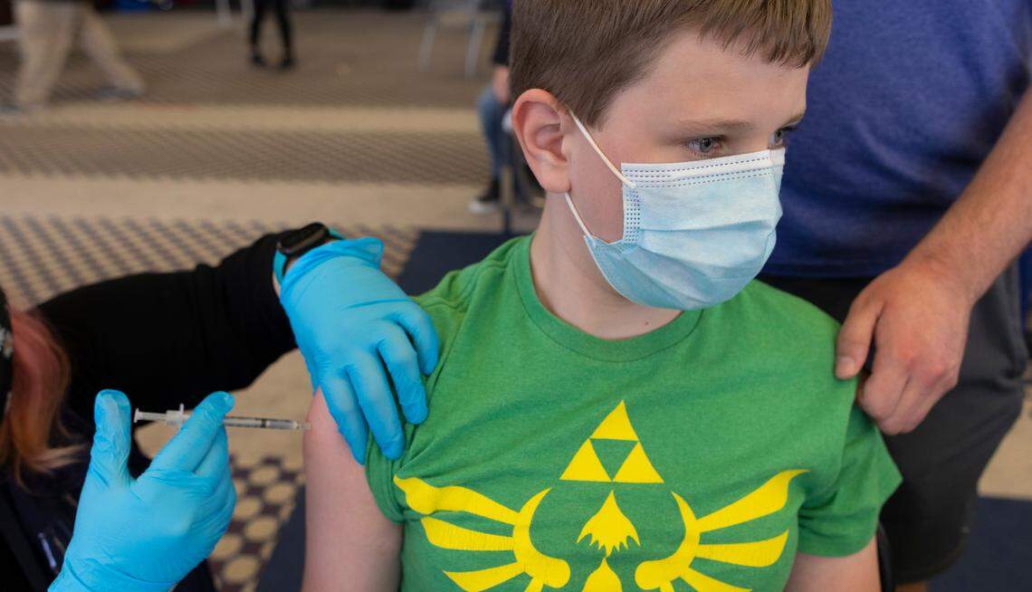 Jacob Wentling, 12, gets the Pfizer shot at a Wichita vaccination site. That’s the youngest age vaccines are allowed, for now.