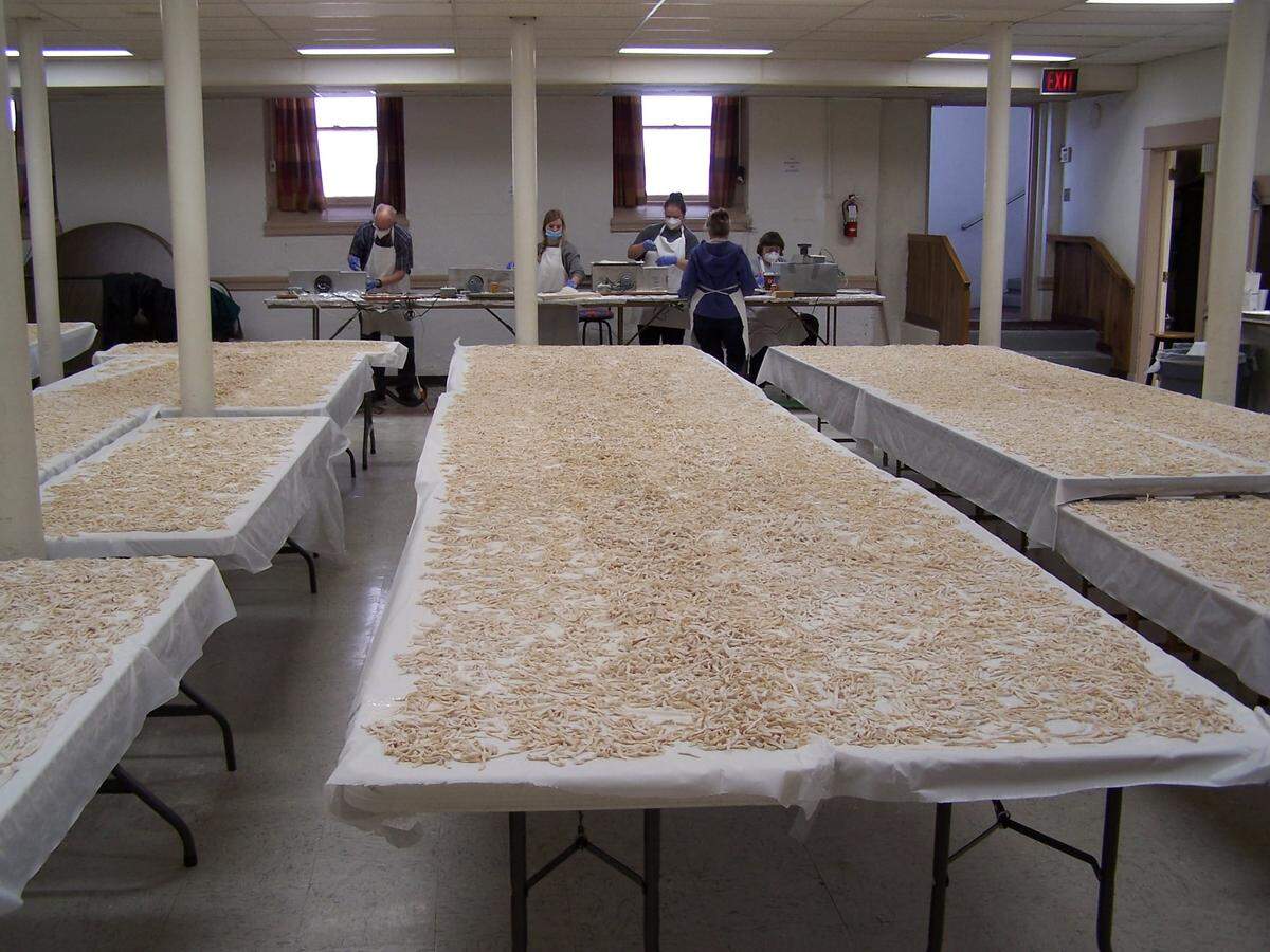 After they make the noodles, members of the St. Paul’s United Methodist Church spread them out to dry on tables in the church hall.