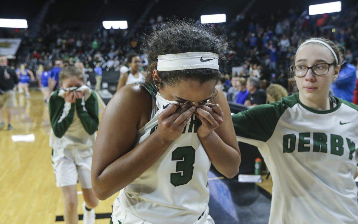 Derby’s Aliyah Myers wipes away tears while walking off the court after Washburn Rural beat the defending state champs in the 6A semifinals at Koch Arena