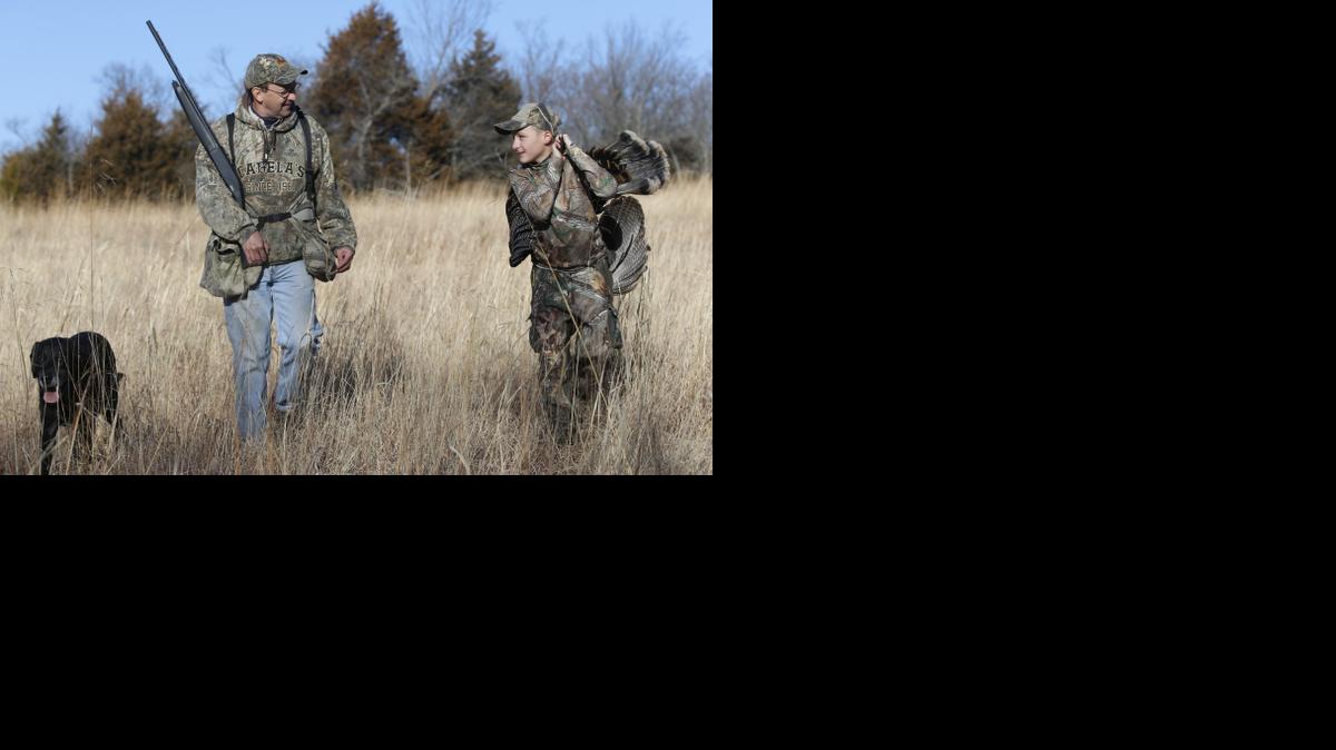 Jacob Holem, right, carries a turkey he shot while hunting with Michael Pearce. They spent about 30 days afield, after Jacob's mom sent an e-mail asking for a mentor to take the 11-year-old hunting. 

