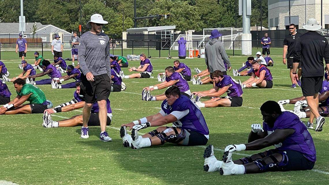 Kansas State offensive coordinator Collin Klein greets players before the start of a football practice in Manhattan.