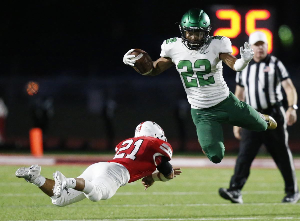 Derby running back Tre Washington jumped over Maize defender Jose Ledesma on his way to a 60-plus yard touchdown run. (October 19, 2018)