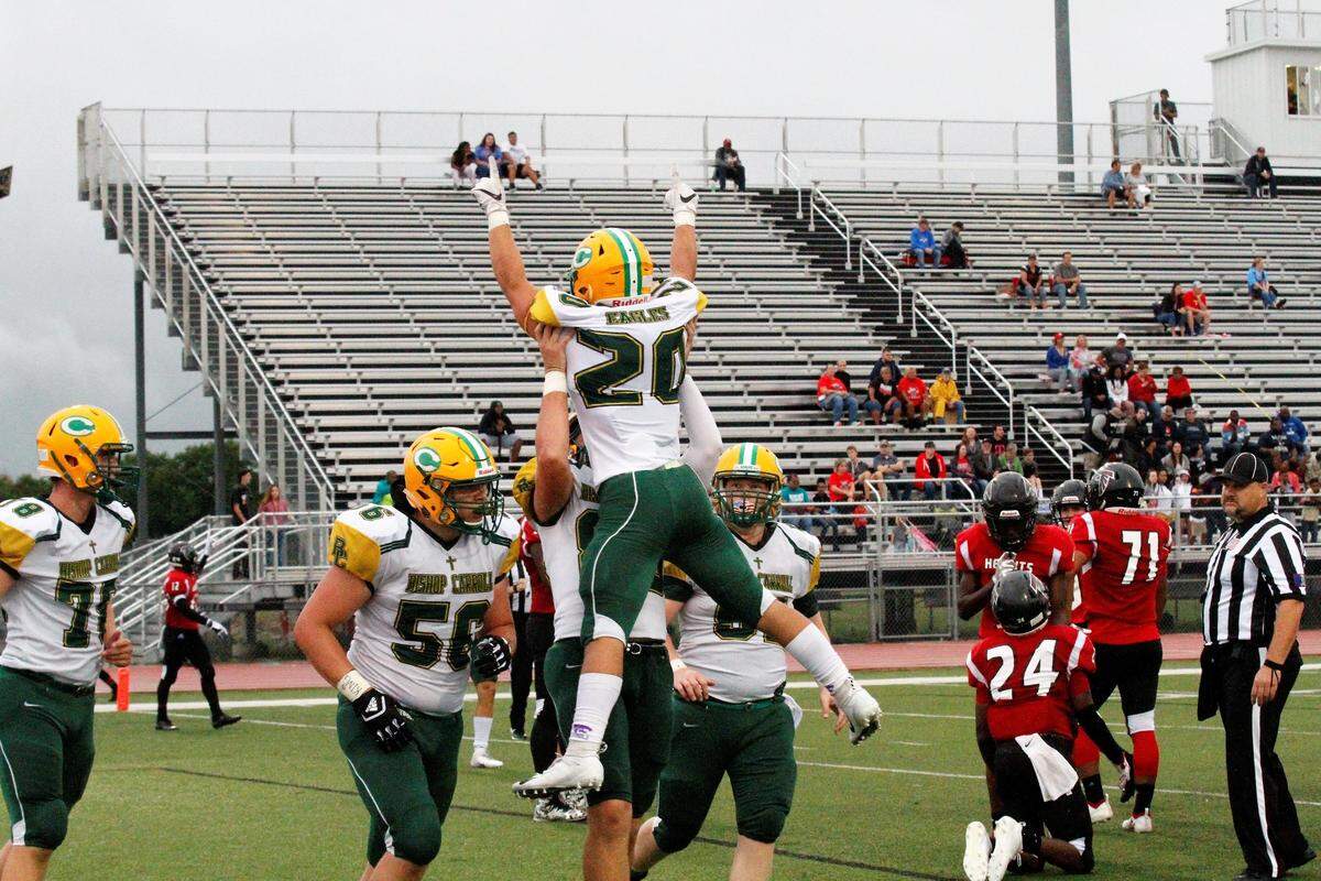 Jackson Nichols, a Bishop Carroll senior running back, celebrates his first of three touchdowns against Wichita Heights in the Golden Eagles’ 36-20 win over the Falcons on Friday. (Sept. 7, 2018)