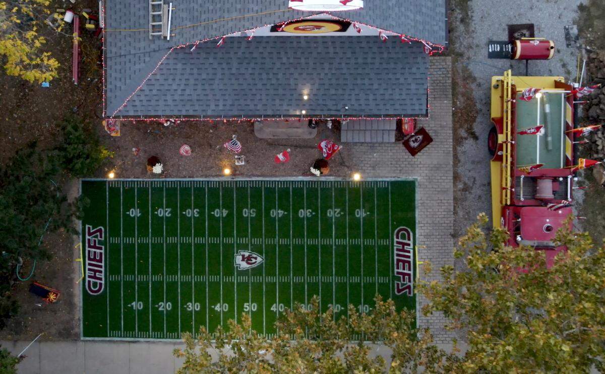 Dennis Basye made this field using a 3-D stencil he created to meticulously lay down the yard lines and Chiefs logo. At right is his 1965 firetruck that is emblazoned in Chiefs’ logos.