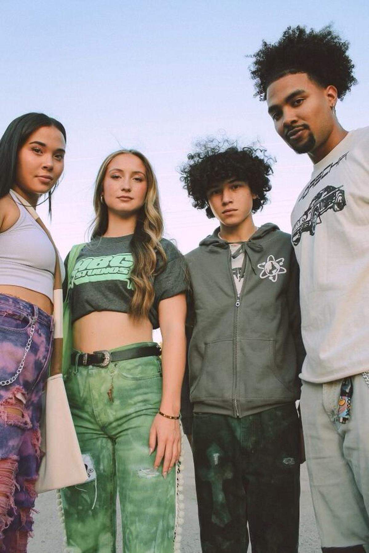 Mark Lozada, right, and some models showing off the clothing he makes.
