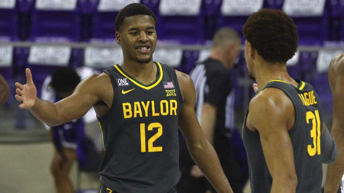 Baylor guard Jared Butler (12) celebrates the win over TCU with guard MaCio Teague (31) after an NCAA college basketball game, Saturday, Jan. 9, 2021, in Fort Worth, Texas. (AP Photo/ Richard W. Rodriguez)