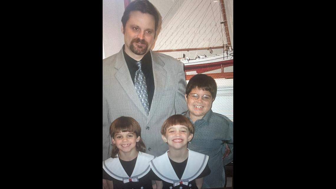 An older family photo of Jesse Pitcher (top right) with his father and his younger sisters.