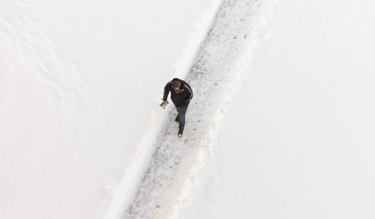 A pedestrian makes their way into the Epic Center a day after Wichita was blanketed with several inches of snow. 